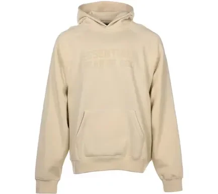 The hoodie is made from cotton and has an "eggshell" color that resembles a shade of cream. It has long sleeves with ribbed cuffs and also features the Essentials branding in toned velvet on the chest area and on the collar as well as the attached hoodie.